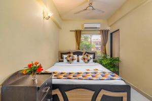 a bedroom with a bed and a table and a window at 4bhk Stunning Apartment with Pool 2bhkX2 in Old Goa