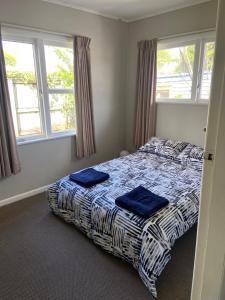 a bedroom with a bed with two blue towels on it at 3-bedroom unit within walking distance to city in Hamilton