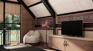 a living room with a flat screen tv on a table at Jawa Jiwa G-Land Resort in Dadapan
