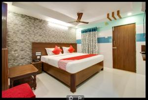 a bedroom with a large bed with a red blanket at Hotel Sri Grand 