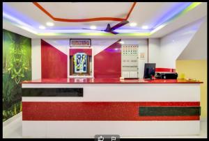 a red and white counter in a room with aperature at Hotel Sri Grand 
