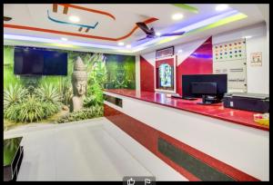 a room with a bar with a painting on the wall at Hotel Sri Grand 