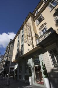 a building on a street in front at Hotel & Residence Torino Centro - Stazione Porta Susa in Turin