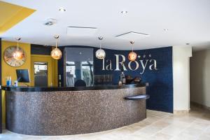 a bar in a restaurant with a sign that reads la rova at Hôtel La Roya in Saint-Florent