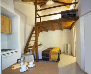 a room with a loft bed in a kitchen at Cugnana Porto Rotondo Bungalows - Camping in Cugnana