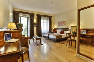 a hotel room with a bed and a desk at Hotel & Residence Torino Centro - Stazione Porta Susa in Turin