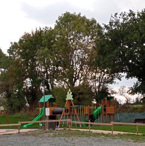 a park with a playground with a slide at La poule aux oeufs dort in Soudan