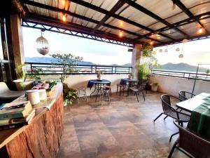 a patio with tables and chairs and a large window at Kalis Viewpoint Lodge Coron in Coron