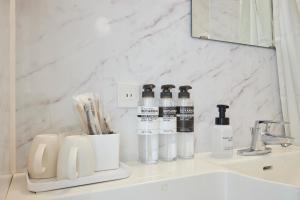 a bathroom sink with two bottles ofodorizers on it at 花築浅草和心ホテル in Tokyo