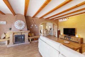 a living room with a couch and a fireplace at Villa Gota de Mar in Jávea +45 photos