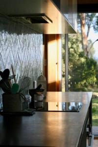 a kitchen with a counter top with a window at Seagrass on Sunset Bay in Alonnah