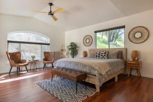 a bedroom with a large bed and two windows at Villa near Yosemite & bass lake w/Hot Tub/EVcharge in Oakhurst