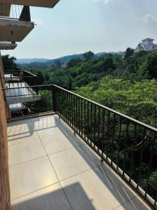 a balcony of a house with a view of trees at Hotel Casa De Patio in Porvorim