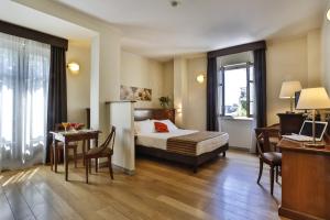 a hotel room with a bed and a table and a desk at Hotel & Residence Torino Centro - Stazione Porta Susa in Turin +87 photos