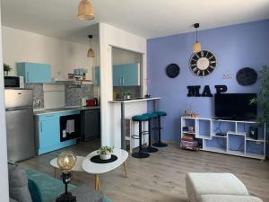 a large living room with a kitchen and a living room at 38 Maison entière,place de parking et garage pour moto velo in Dunkerque