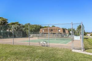 a tennis court with two chairs on it at Casa Bella 105 in Fort Myers