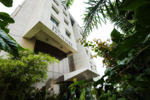 a building with a sign on the side of it at Hotel Solitaire in Pune