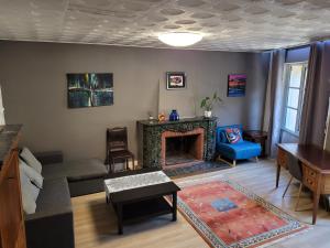 a living room with a couch and a fireplace at Bel Appartement Bagneres De Luchon Centre in Luchon