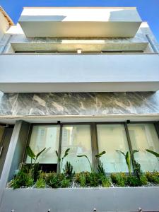 a window box with plants on the side of a building at APHRODITE 2 Bedroom Apartment Down Town Nicosia By Platform 357 in Nicosia