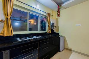 a bathroom with a sink and a window at 2BHK Stunning Apartment with Pool in Vagator
