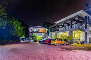 two cars parked in a parking lot in front of buildings at 2BHK Stunning Apartment with Pool in Vagator