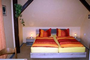 a bedroom with a large bed with red pillows at Ruegen_Fewo 285 in Neu Mukran