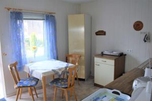 a kitchen with a table and two chairs and a table and a table at Ruegen_Fewo 285 in Neu Mukran