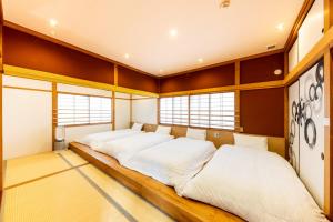 Una cama o camas en una habitación de Yuimaru EAST - 最大18名貸切OK