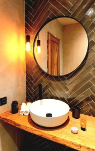 a bathroom with a sink and a mirror on a counter at KOKICHE 4 Friends, Borovets in Borovets