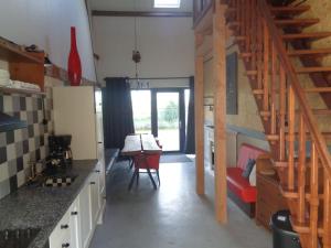 a kitchen with a staircase and a table in a room at appartement met 5 slaapkamers in Moerstraten