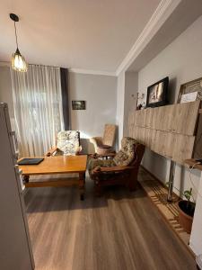 a living room with a table and two chairs at Guest house Amazon in Kutaisi