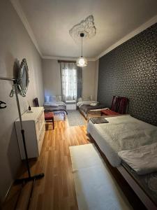 a bedroom with a bed and a living room at Guest house Amazon in Kutaisi