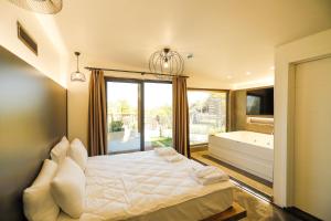 a bedroom with a bed and a tub and a window at World DREAMS Forest in Sapanca