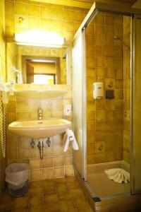 a bathroom with a sink and a shower at Hotel HAAS in Bad Gastein +52 photos