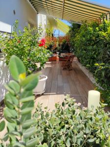 a patio with a bunch of plants and tables at Le casette in Monopoli