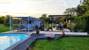 a backyard with a tiny house and a swimming pool at Ker Isari in Auterive