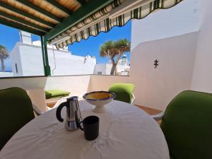a table in a room with a view of the beach at Cozy Waterman beach house in Costa Teguise