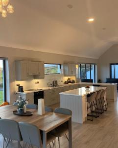 a kitchen with a table and chairs and a dining room at Spectacular ocean views & minutes to Cliffs- Clahane Shore Lodge in Liscannor