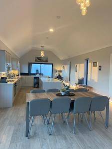 a kitchen and dining room with a table and chairs at Spectacular ocean views & minutes to Cliffs- Clahane Shore Lodge in Liscannor
