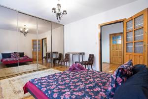 a bedroom with a bed and a dining room at Apartament na Fatimskiej in Krakow