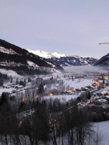 a snow covered valley with a town in the distance at Penthousewohnung Gasteinblick in Bad Gastein