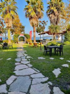 a stone path in a park with tables and chairs at Peri Boutique Hotel in Sapanca