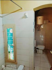 a bathroom with a toilet and a window at Touha House in Fayoum Center