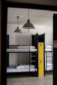 a room with three bunk beds and two lights at ONRest Hostel Centrum Żytnia 8 in Kielce