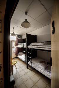 a room with three bunk beds and a window at ONRest Hostel Centrum Żytnia 8 in Kielce