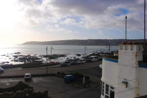 a view of a parking lot next to the water at The Yacht Inn in Penzance