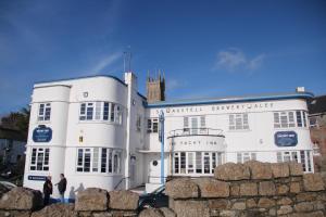 two people standing in front of a white building at The Yacht Inn in Penzance