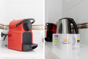 a red suitcase and a coffee maker and a coffee pot at Elegance Barcelona Rentals in Barcelona