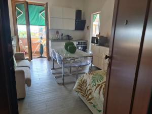 a kitchen with a table and a counter top at Andora Fronte Mare in Marina di Andora