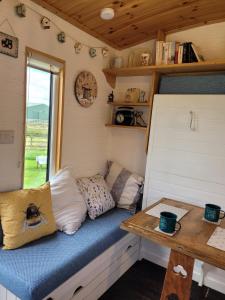 a small room with a bench in a tiny house at The Shepherds Hut at Forestview Farm in Greenisland